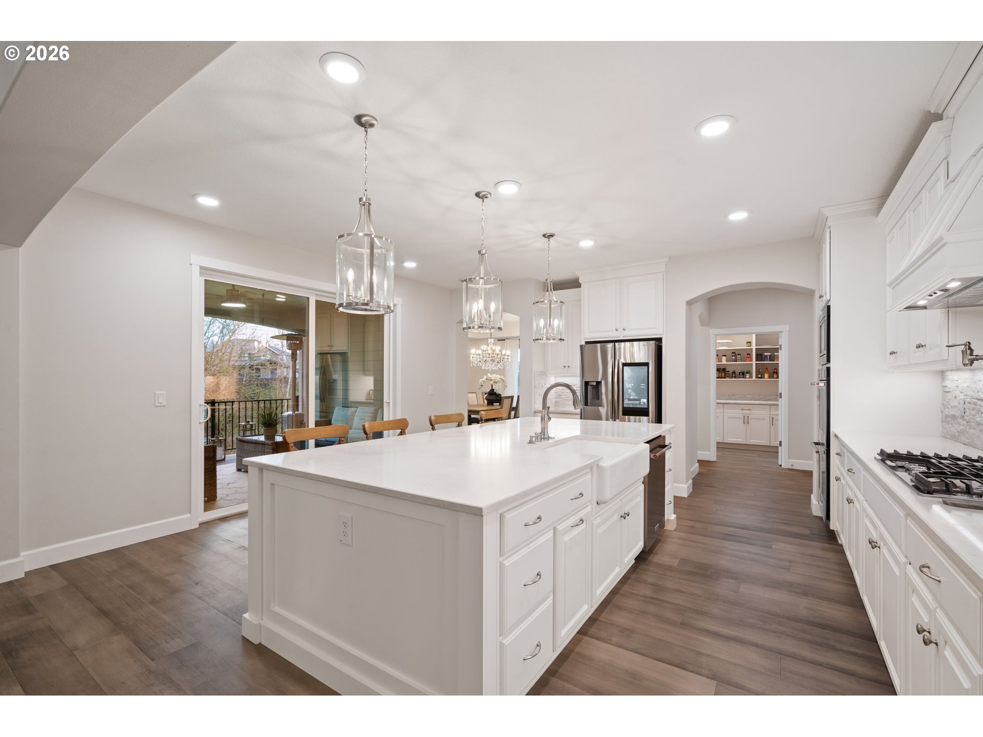 4024 South Winery Way Ridgefield, WA 98642 - Photo 19 of 48 a large kitchen with kitchen island a stove a sink a refrigerator and a view of living room