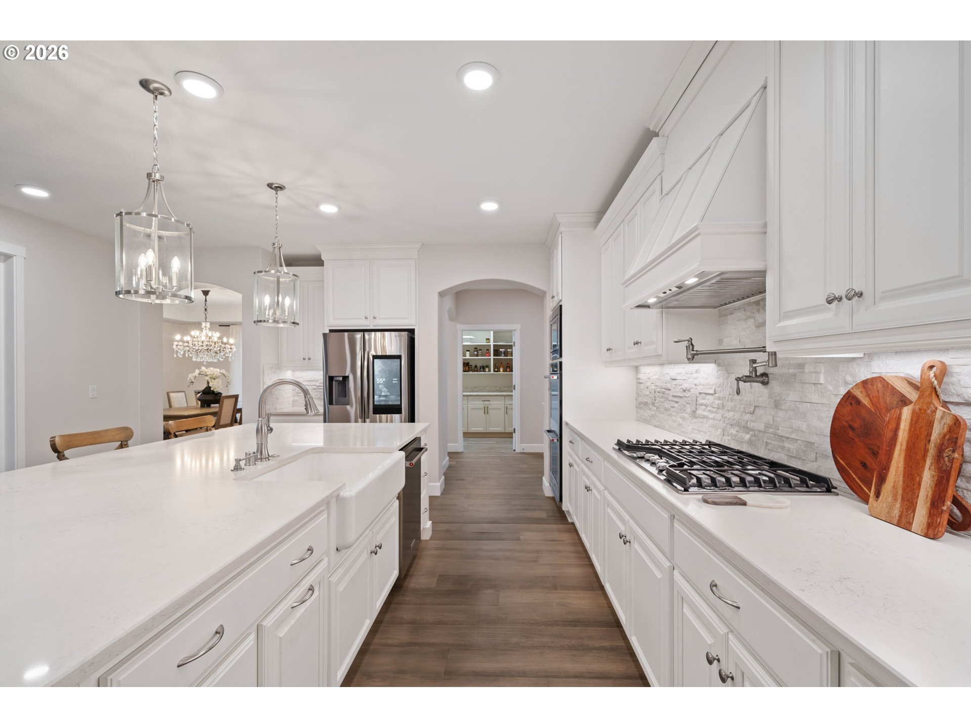 4024 South Winery Way Ridgefield, WA 98642 - Photo 20 of 48 a large kitchen with kitchen island stainless steel appliances a sink a counter top space stove and cabinets