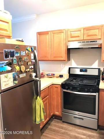 a stove top oven sitting inside of a kitchen