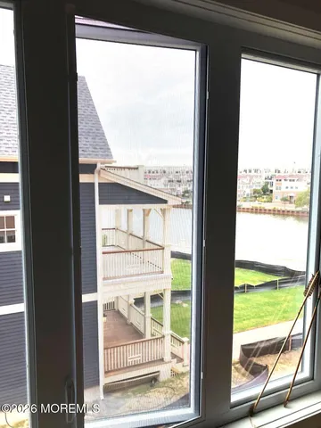 a view of a glass door with a yard from a window