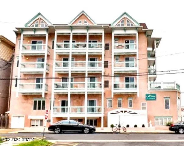 a front view of a residential apartment building with a yard