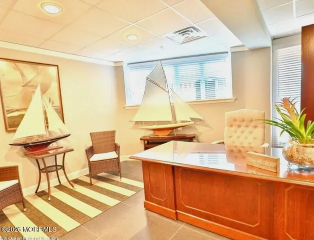 a room with a table chairs and wooden floor