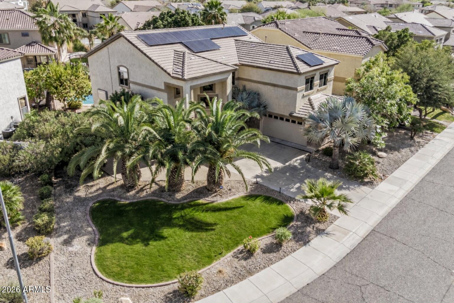 a aerial view of a house with a yard and potted plants