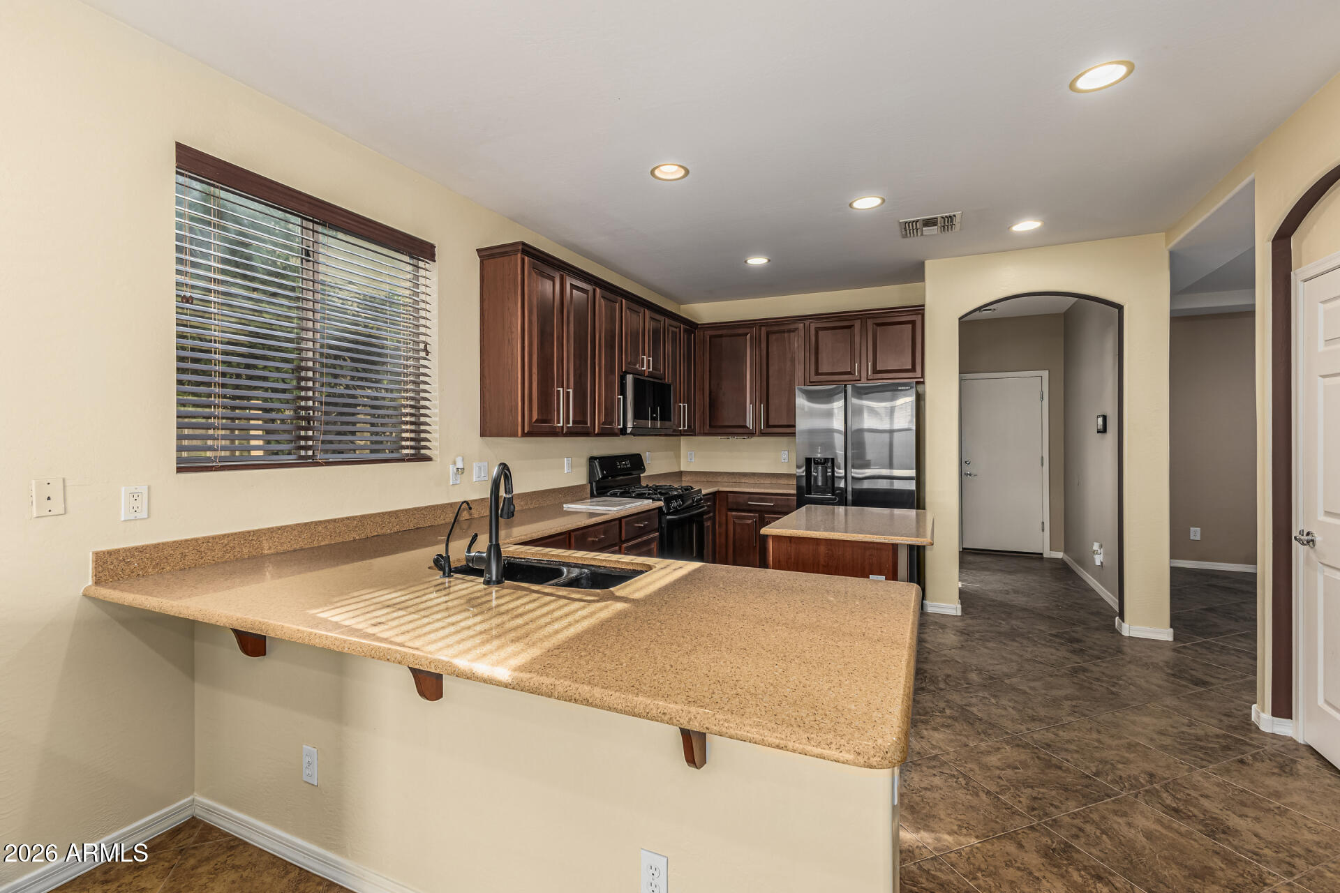 5513 West Rowel Road Phoenix, AZ 85083 - Photo 14 of 55 a kitchen that has a sink and a stove