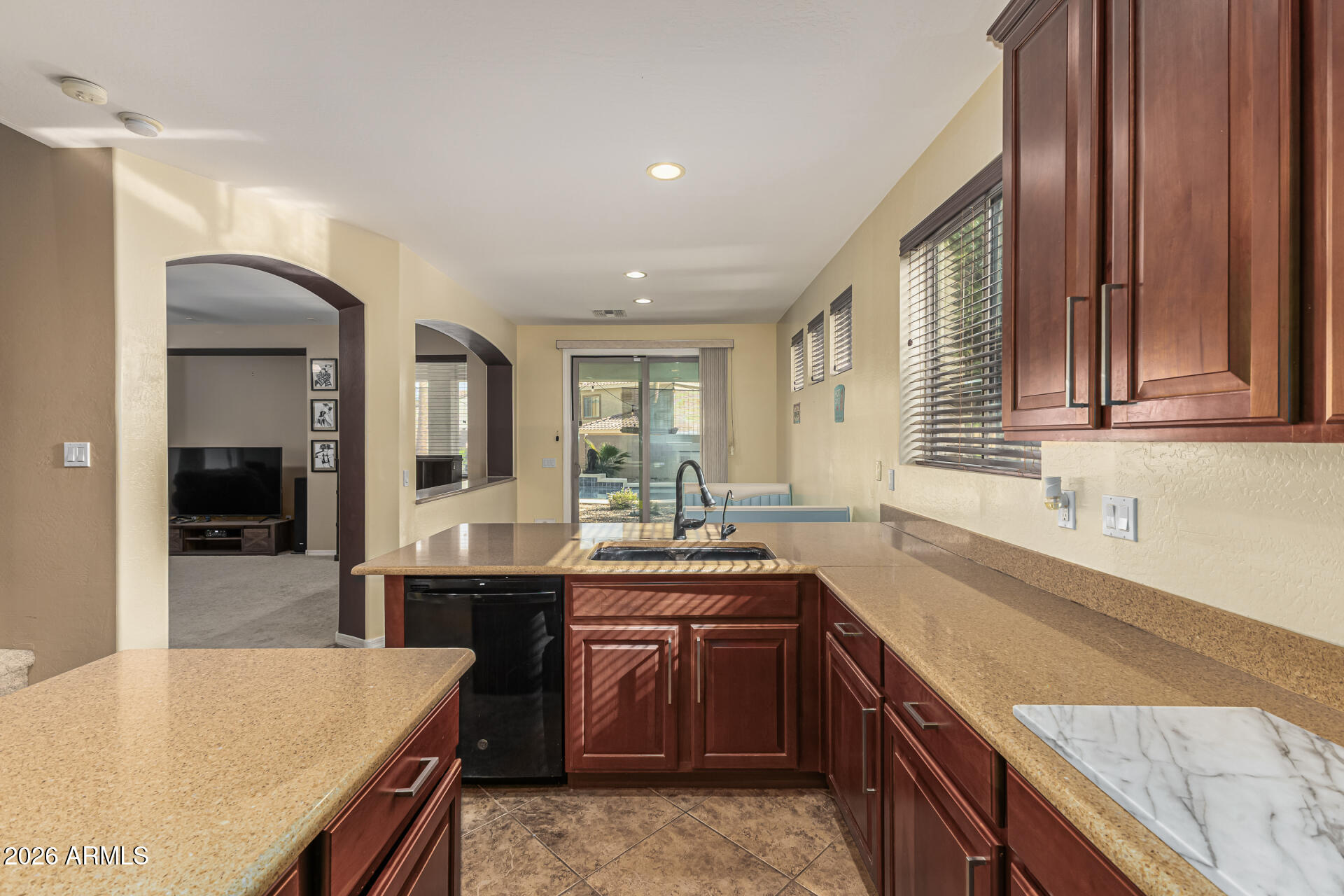 5513 West Rowel Road Phoenix, AZ 85083 - Photo 15 of 55 a kitchen with granite countertop a sink and cabinets