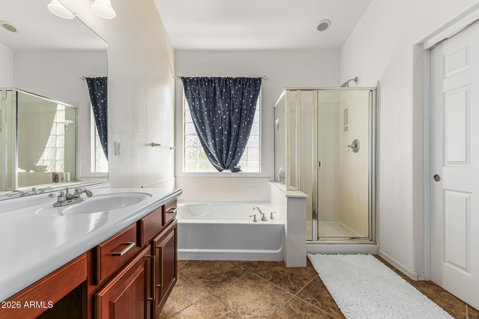 5513 West Rowel Road Phoenix, AZ 85083 - Photo 23 of 55 a bathroom with a tub sink and mirror