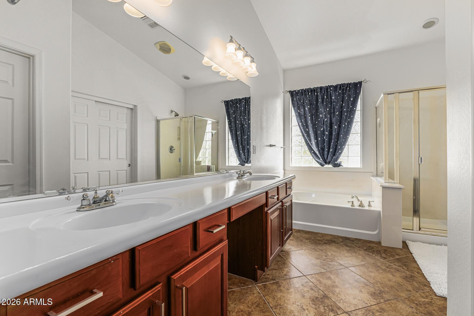5513 West Rowel Road Phoenix, AZ 85083 - Photo 24 of 55 a bathroom with a tub a sink double vanity and a mirror