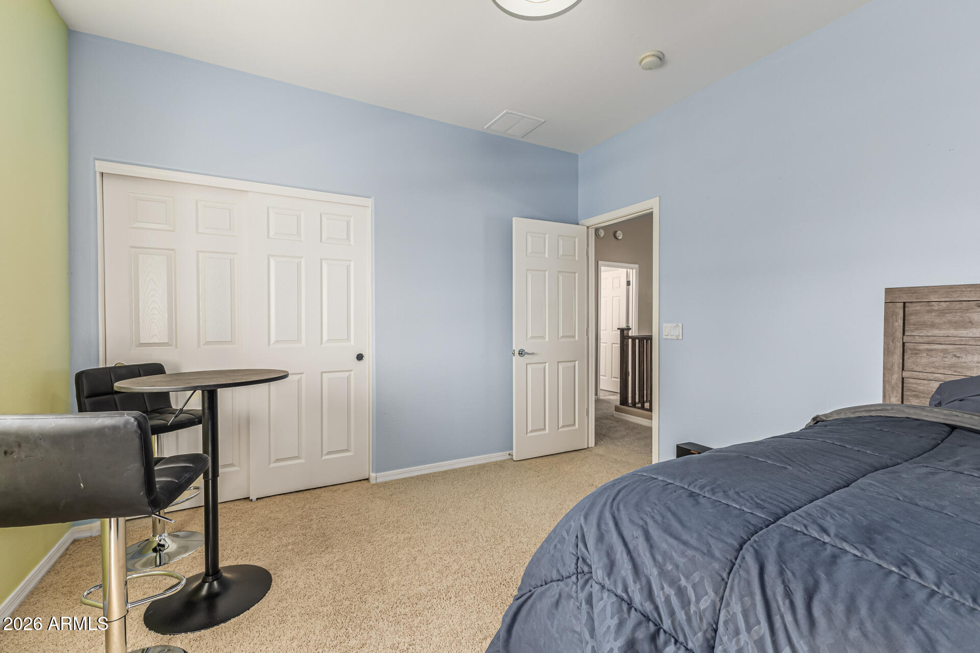 5513 West Rowel Road Phoenix, AZ 85083 - Photo 27 of 55 a bedroom with a bed and a chair
