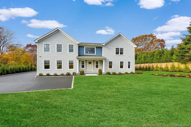 a view of house with backyard and garden