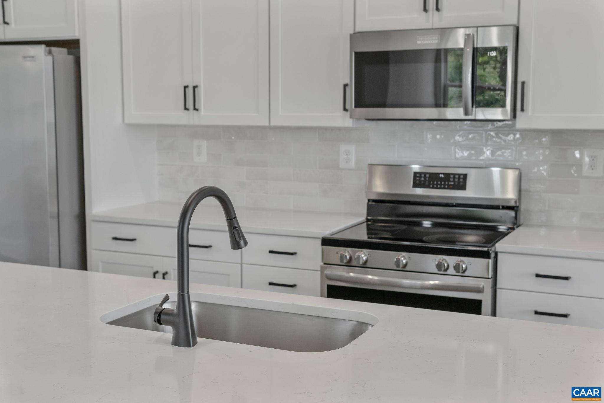 746 Park Ridge Drive Crozet, VA 22932 - Photo 13 of 46 a kitchen with granite countertop a stove and a sink