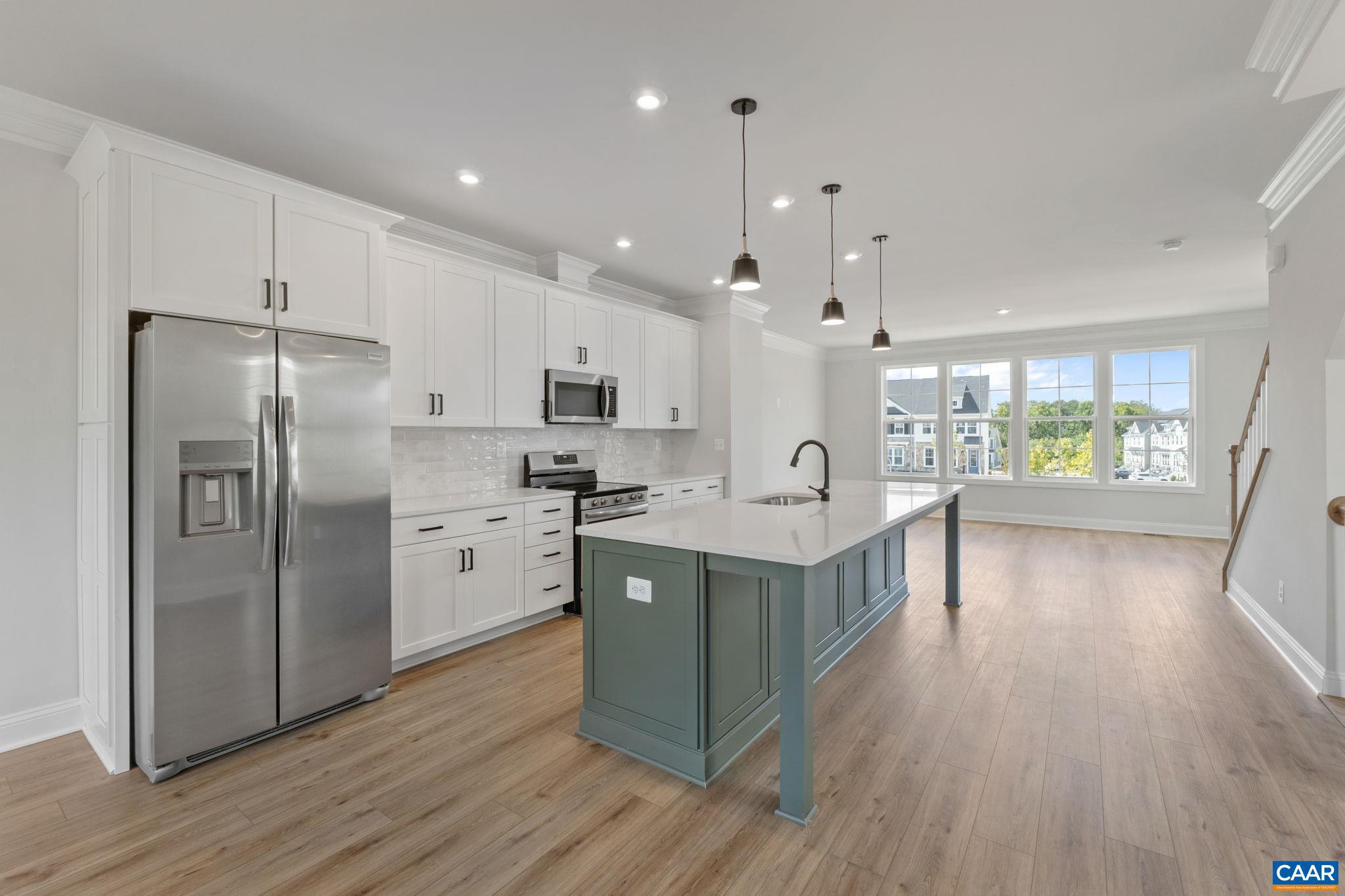 746 Park Ridge Drive Crozet, VA 22932 - Photo 18 of 46 a kitchen with stainless steel appliances granite countertop a refrigerator a sink dishwasher a stove and a dining table with wooden floor