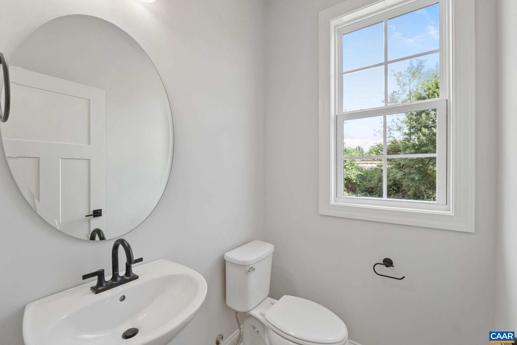 746 Park Ridge Drive Crozet, VA 22932 - Photo 24 of 46 a bathroom with a toilet a sink a mirror and a window