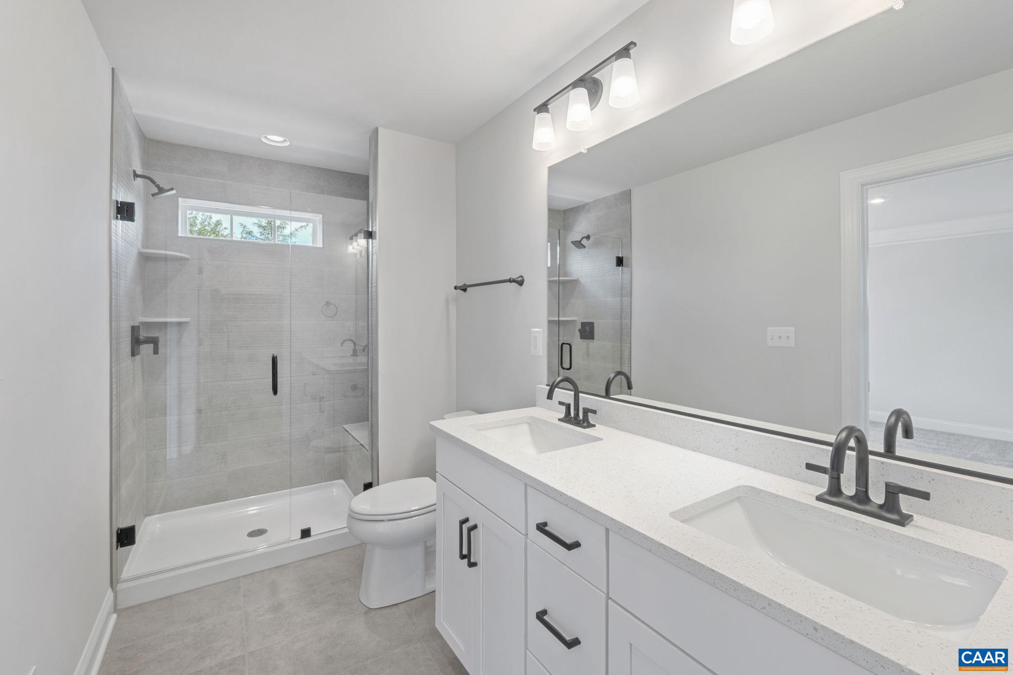 746 Park Ridge Drive Crozet, VA 22932 - Photo 33 of 46 a bathroom with a double vanity sink toilet mirror and shower
