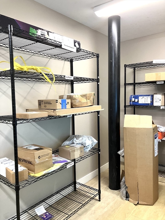 130 John Street, Unit G01 Lowell, MA 01852 - Photo 12 of 40 a room with wooden floor and furniture