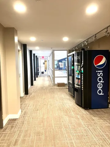 a lobby with furniture and floor to ceiling window