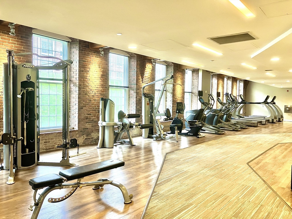 130 John Street, Unit G01 Lowell, MA 01852 - Photo 15 of 40 a lobby with furniture and floor to ceiling window