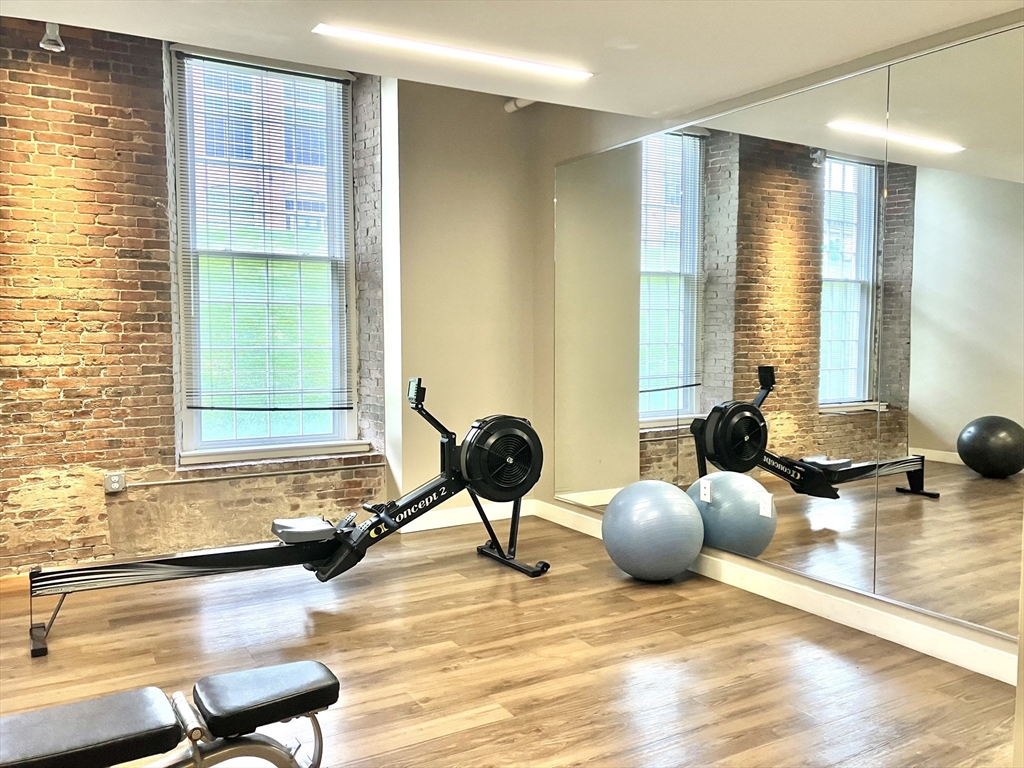 130 John Street, Unit G01 Lowell, MA 01852 - Photo 16 of 40 a bedroom with furniture and a large window