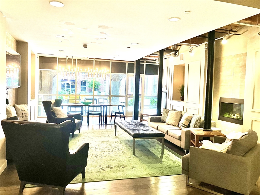 130 John Street, Unit G01 Lowell, MA 01852 - Photo 18 of 40 a living room with furniture and a large window