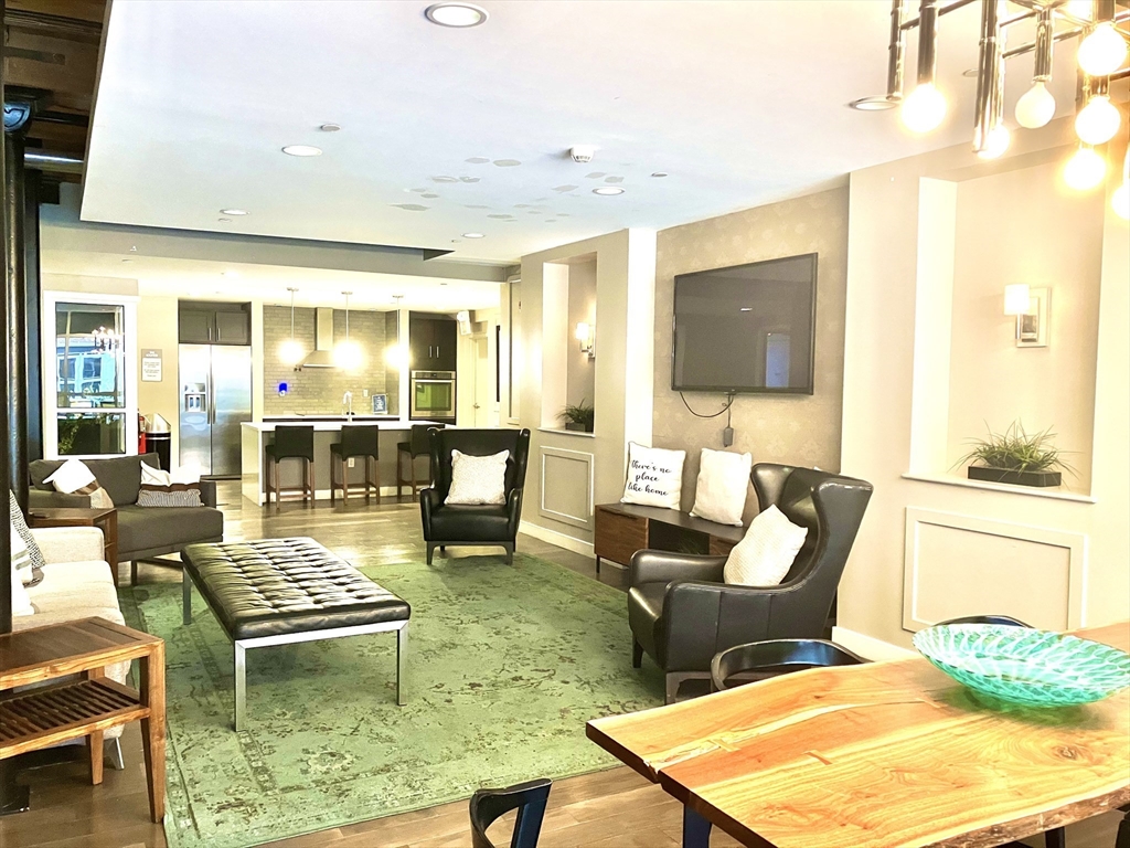 130 John Street, Unit G01 Lowell, MA 01852 - Photo 19 of 40 a living room with furniture and a flat screen tv