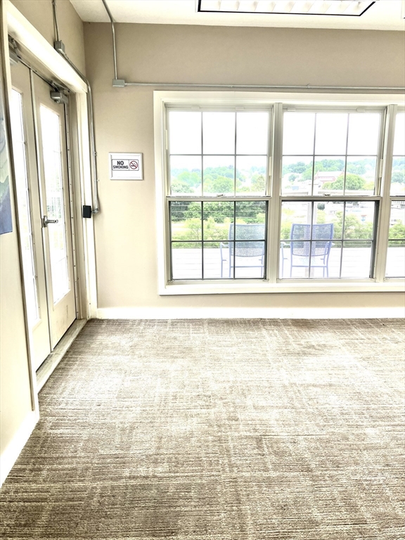 130 John Street, Unit G01 Lowell, MA 01852 - Photo 27 of 40 a view of an empty room and window