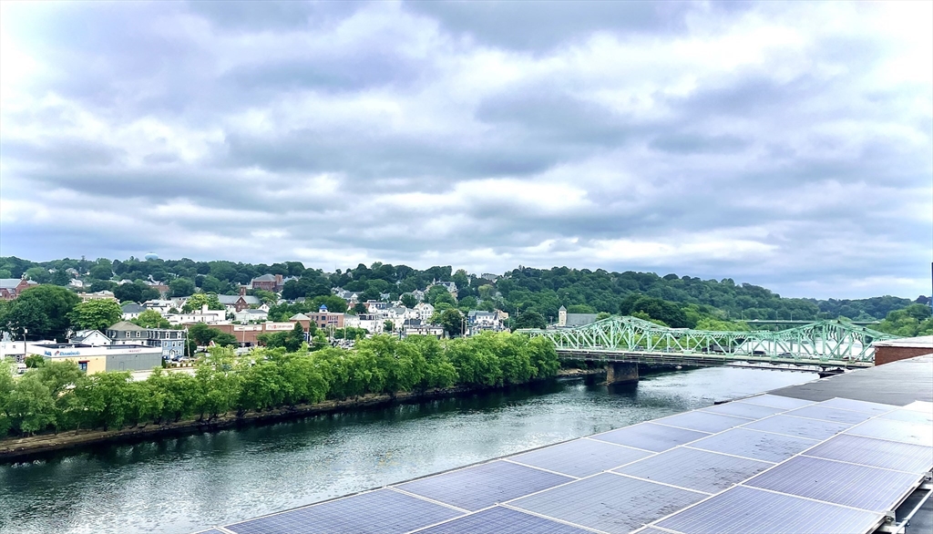130 John Street, Unit G01 Lowell, MA 01852 - Photo 30 of 40 a view of a lake with a yard