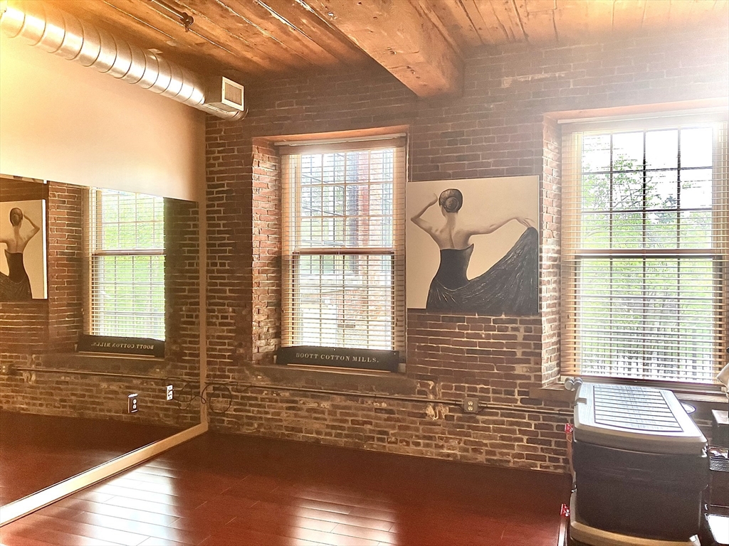 130 John Street, Unit G01 Lowell, MA 01852 - Photo 34 of 40 a view of a livingroom with wooden floor and a large window