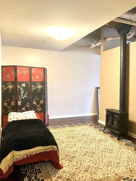 130 John Street, Unit G01 Lowell, MA 01852 - Photo 39 of 40 a bedroom with a bed and a window