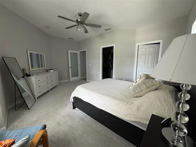 a bedroom with a bed and a couch