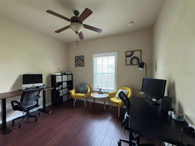 a view of a workspace with furniture and a window