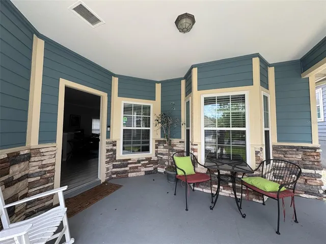 a view of a bedroom with chair and tables