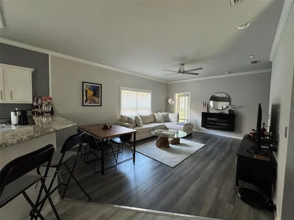 a living room with furniture and wooden floor