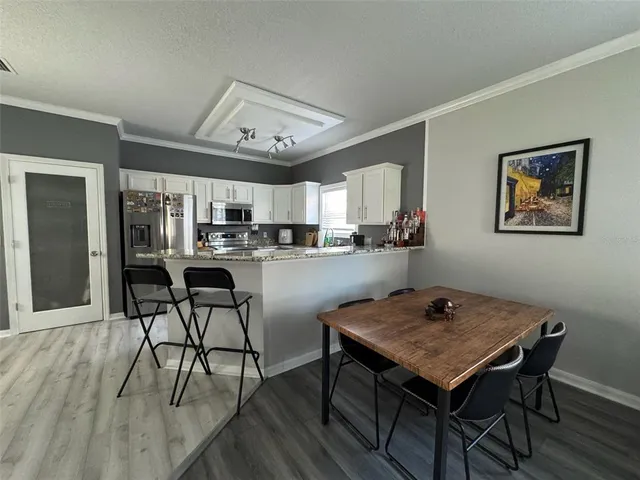 a view of a dining room with furniture and wooden floor