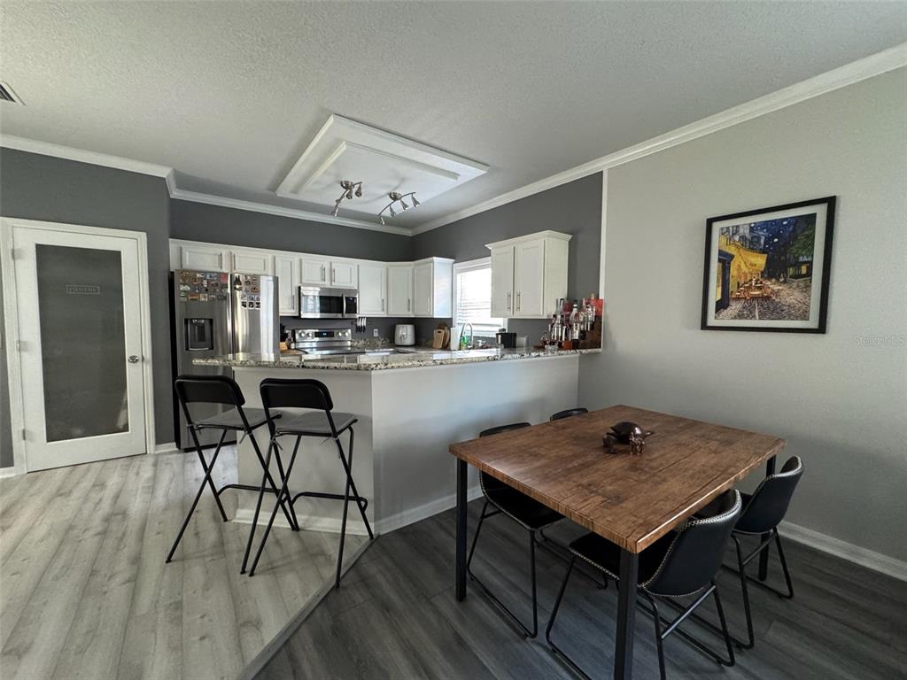 1376 Northwest 120th Way Gainesville, FL 32606 - Photo 7 of 21 a view of a dining room with furniture and wooden floor