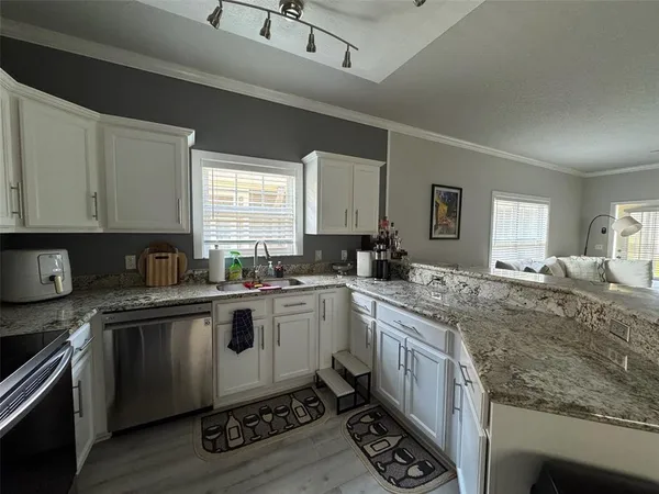 a kitchen with a sink stove and cabinets