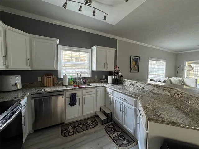 a kitchen with a sink stove and cabinets