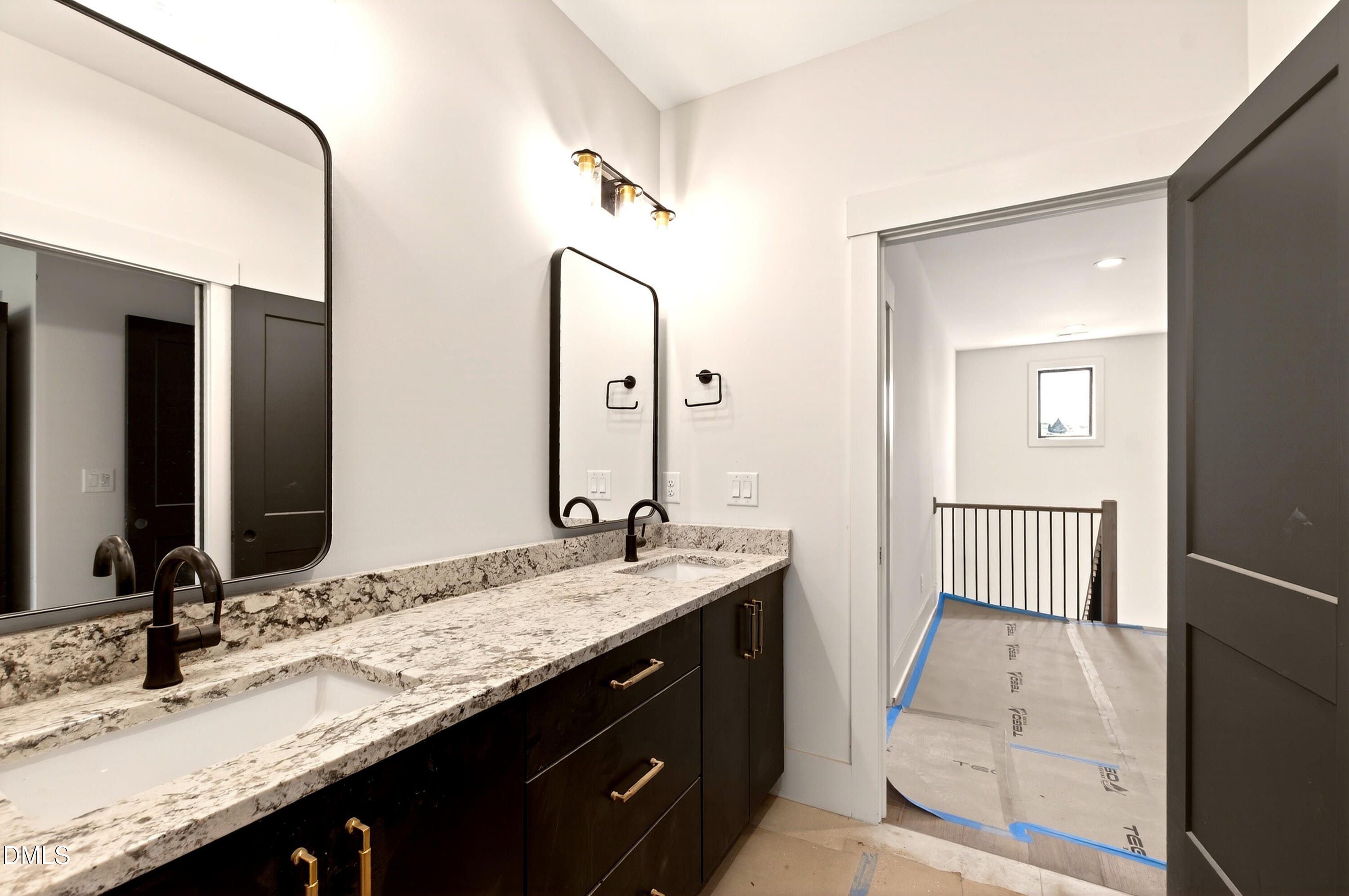 909 Oberlin Road Raleigh, NC 27605 - Photo 31 of 59 a bathroom with a granite countertop sink and a mirror