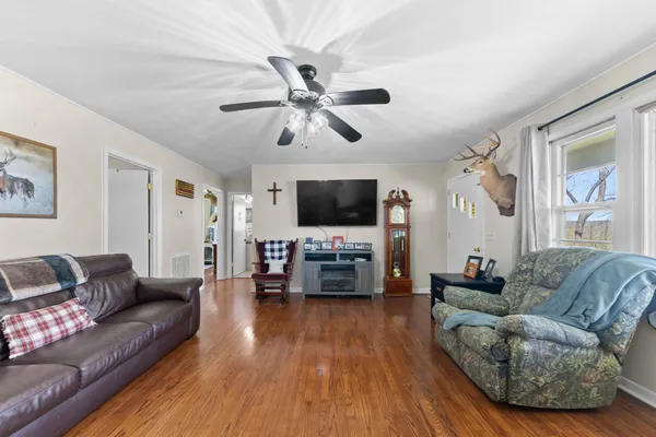 a living room with furniture and wooden floor