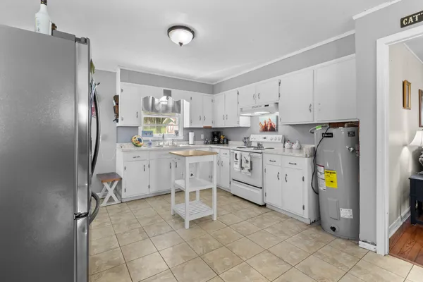 a kitchen with cabinets and refrigerator