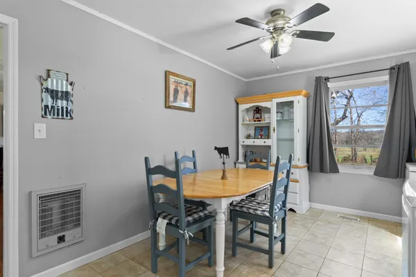 a view of a dining room with furniture and chandelier