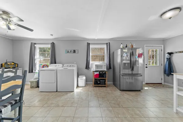 a view of a hallway with wooden floor and furniture