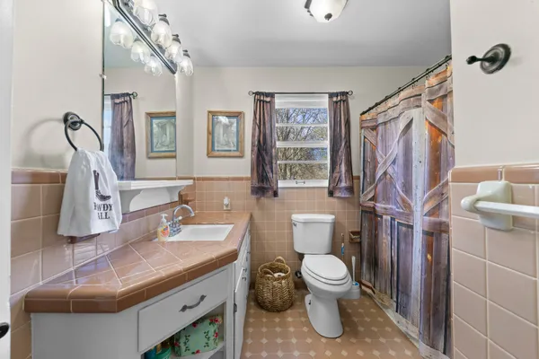 a view of a hallway with wooden floor and closet