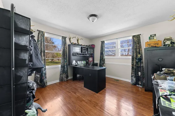 a view of a hallway view with wooden floor and furniture