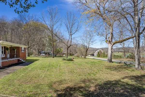 a backyard of a house with garden and outdoor seating