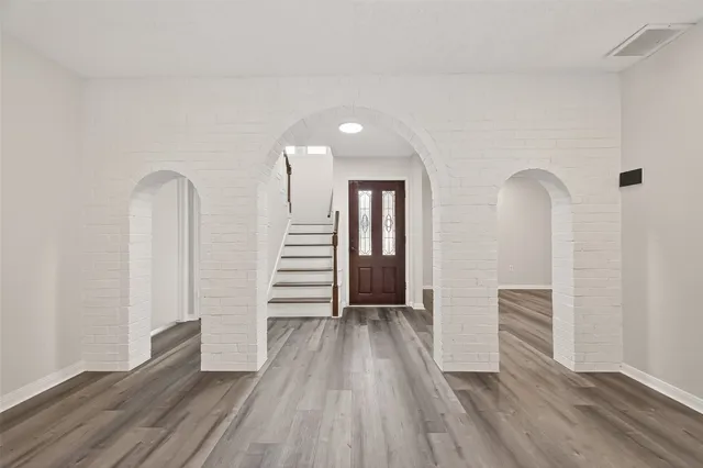 wooden floor in an empty room with a ceiling fan