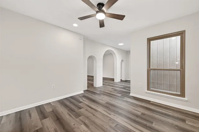 a view of backyard with wooden fence and a large tree