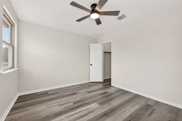 a view of a house with backyard and a tree
