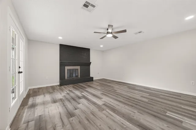 wooden floor in an empty room with a window
