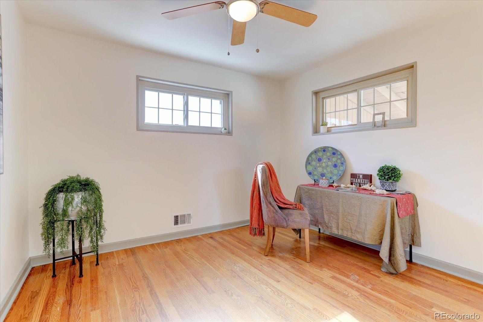 7141 Raritan Street Denver, CO 80221 - Photo 13 of 29 a workspace room with furniture and wooden floor