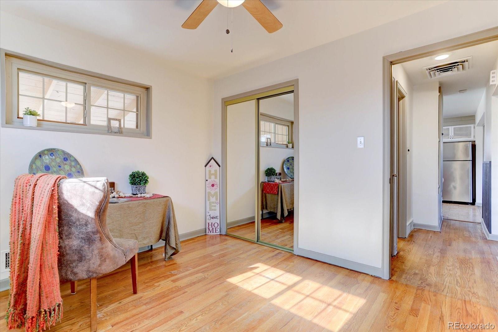 7141 Raritan Street Denver, CO 80221 - Photo 14 of 29 a workspace room with furniture and wooden floor