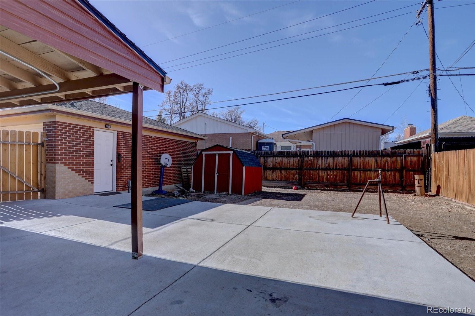 7141 Raritan Street Denver, CO 80221 - Photo 25 of 29 a view of a patio with table and chairs
